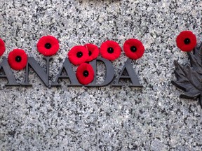 Poppies are seen on the National War Memorial after Remembrance Day ceremonies, in Ottawa on Sunday, Nov. 11, 2018. The Royal Canadian Legion is selling non-medical masks and will roll out electronic payment options during this year's poppy campaign that has been adjusted for the pandemic.THE CANADIAN PRESS/Justin Tang