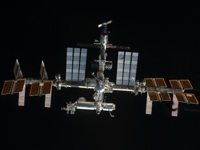 The International Space Station hangs in space in this image taken by a space shuttle that visited it in 2011.