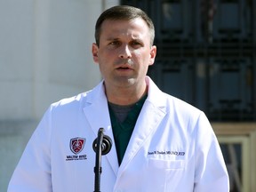 Dr. Sean Dooley speaks during a press conference outside of Walter Reed National Military Medical Center in Bethesda, Maryland, U.S., on Sunday, Oct. 4, 2020.