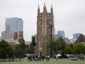 People take a break from playing sports on the grounds of the University of Toronto in Toronto, Ontario, Canada September 9, 2020.