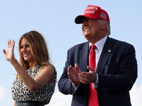 U.S. President Donald Trump applauds as first lady Melania Trump waves during his campaign rally outside Raymond James Stadium, in Tampa, Florida, U.S., October 29, 2020.