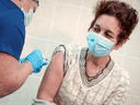 A nurse inoculates a volunteer with Russia's 