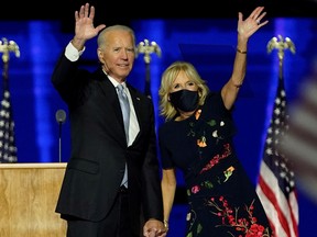 U.S. President-elect Joe Biden with his wife Jill Biden salute the crowd on stage after delivering remarks in Wilmington, Delaware, on November 7, 2020, and being declared the winner of the U.S. presidential election.
