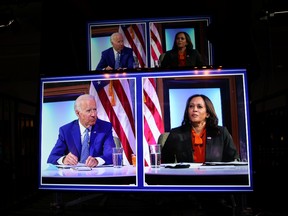 U.S. president elect Joe Biden and Vice president-elect Kamala Harris appear on video screens as they hold a virtual meeting with their coronavirus disease (COVID-19) advisory council in Wilmington, Delaware, U.S. November 9, 2020.