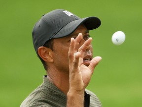Tiger Woods of the United States catches a ball on the 16th hole during the first round of the Masters at Augusta National Golf Club on November 12, 2020 in Augusta, Georgia.