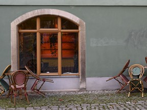 Stools and tables stand together in front of a closed cafe in Weimar, Germany, on November 14, 2020, amid the ongoing novel coronavirus Covid-19 pandemic.