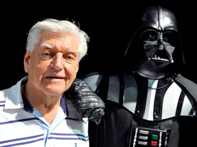 David Prowse, left, the British actor behind the menacing black mask of "Star Wars" villain Darth Vader who died on Nov. 29, attends a "Star Wars" convention in 2013.