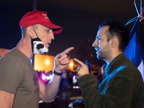 Supporter of U.S. President Donald Trump (L) argues with a man holding a Democratic Party flag during a "Stop the Steal" protest at Clark County Election Center in North Las Vegas, Nevada, U.S. November 5, 2020.