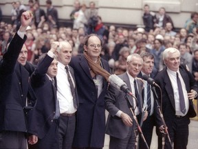 Aquitted members of the Birmingham Six, sent to prison in 1975 for the IRA's bombing of two pubs, gather with their MP after they walk from court as free men.