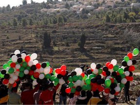 Palestinian demonstrators prepare to release balloons during a protest against U.S. Secretary of State Mike Pompeo's visit, near the Israeli settlement of Psagot in the Israeli-occupied West Bank November 18, 2020.