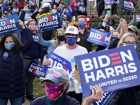Supporters of U.S. Democratic presidential nominee Joe Biden hold sings at a canvassing stop, on Election Day in Philadelphia, Pennsylvania, U.S. November 3, 2020.