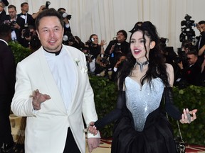 Elon Musk, left, and his partner Grimes arrive at a gala at the Metropolitan Museum of Art in New York in 2018.