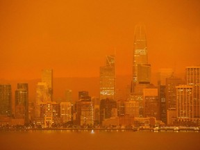 The San Francisco skyline is obscured in orange smoke and haze as their seen from Treasure Island in San Francisco, California on September 9, 2020.