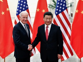 Joe Biden, then U.S. vice-president, shakes hands with Chinese President Xi Jinping inside the Great Hall of the People in Beijing, in a file photo from Dec. 4, 2013.