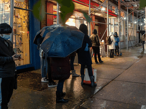 People stand in line outside a medical clinic for COVID-19 testing on October 29, 2020 in New York City.