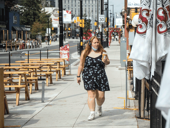  A woman walks by empty patios on Elgin Street in Ottawa. Restaurants suspect they are being “scapegoated” as a source of COVID-19 infections based on weak evidence.