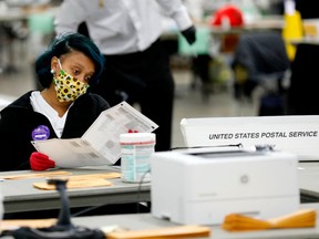 Detroit election workers work on counting absentee ballots for the 2020 general election at TCF Center on November 4, 2020 in Detroit, Michigan. Photo by JEFF KOWALSKY/AFP via Getty Images.