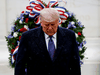 U.S. President Donald Trump turns away in the rain after laying a wreath at the Tomb of the Unknown Solider during a Veterans Day observance in Arlington National Cemetery, Virginia, November 11, 2020.