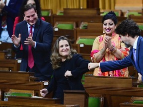 Minister of Finance Chrystia Freeland gets a fist bump from Prime Minister Justin Trudeau after delivering the 2020 fiscal update in the House of Commons on Parliament Hill in Ottawa on Monday, Nov. 30, 2020.