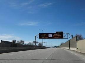 A digital traffic sign is seen above an empty highway in Ottawa, on April 4.