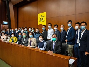 Pro-democracy lawmakers pose for a photograph during a news conference to announce their mass resignation at the Legislative Council in Hong Kong, China, on Wednesday, Nov. 11, 2020.