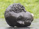 The decapitated head of a statue of Sir Canada's first prime ministerJohn A. Macdonald lies on the ground following a protest in Montreal in August 2020.
