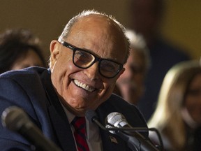 Rudy Giuliani, personal lawyer to U.S. President Donald Trump, smiles during a Pennsylvania Senate Majority Policy Committee hearing in Gettysburg, Pennsylvania, U.S., on Wednesday, Nov. 25, 2020. PHOTO BY Craig Hudson/Bloomberg