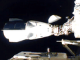 NASA's SpaceX Crew-1 mission aboard the SpaceX Crew Dragon, left, docks at the International Space Station on November 16, 2020.