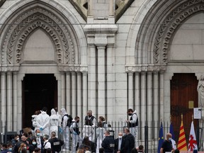 French police officers and forensic officers work on the scene of the knife attack in front of Notre Dame church, in Nice, France, on Oct. 29. Prime Minister Justin Trudeau condemned what he describes as a deadly terrorist attack.