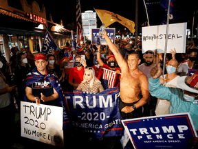 Supporters of U.S. President Donald Trump react as they listen to Trump speak in a broadcast during a protest about the early results of the 2020 presidential election in Miami, Florida, November 5, 2020.