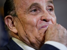 Former New York City Mayor Rudy Giuliani, personal attorney to U.S. President Donald Trump, wipes away sweat as he speaks about the 2020 U.S. presidential election results during a news conference in Washington, U.S., November 19, 2020.