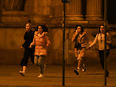 Women run away from the first district near the state opera, central Vienna on November 2, 2020, following a shooting near a synagogue.