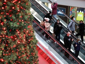 Shoppers wearing mandatory masks pass Christmas Tree, two days before coronavirus disease (COVID-19) restrictions are reintroduced to Greater Toronto Area regions, at Eaton Centre mall in downtown Toronto, Ontario, Canada November 21, 2020.