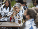 Wearing supplied thermal blankets, patrons at a Toronto pub have a drink on the patio in late October.