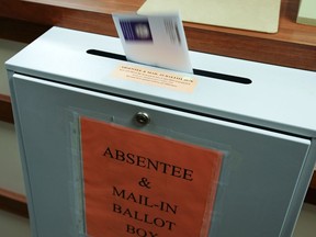 A citizen deposits a ballot into a box at the county clerk's office in Erie, Penn., on Oct. 15, 2020. MUST CREDIT: Washington Post photo by Bonnie Jo Mount