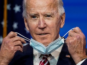 U.S. President-elect Joe Biden removes his face mask to speak about the U.S. economy after attending a briefing in Wilmington, Delaware, U.S., Nov. 16, 2020.
