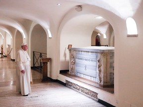 This handout photo taken and released by the Vatican press office, Vatican Media, on November 2, 2020 shows Pope Francis visiting to the tombs of the deceased popes in the necropolis of St. Peter's Basilica at the Vatican.