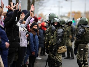 Law enforcement officers block protesters during a march of opposition supporters from central Minsk to a site of Stalin-era executions just outside the capital on November 1, 2020.