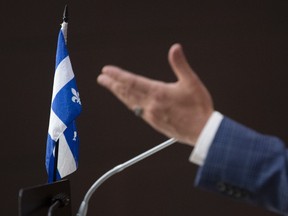 The Quebec flag is seen on the podium as Bloc leader Yves-François Blanchet responds to a question during a news conference Wednesday June 3, 2020 in Ottawa.
