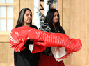 Stephanie Scott, left, of the National Centre for Truth and Reconciliation, and Joyce Hunter, whose brother died at a residential school in 1974, carry a ceremonial cloth with the names of 2,800 children who died in residential schools during the Honouring National Day for Truth and Reconciliation ceremony in Gatineau, Ontario on Sept. 30, 2019.