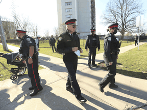 Toronto Police Supt. Ron Taverner, middle, and officers at the location where an innocent 12-year-old boy was shot inadvertently and has now died, on Thursday November 12, 2020.