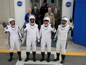 Crew members of a SpaceX Falcon 9 rocket commander Mike Hopkins, Victor Glover, Shannon Walker and Japanese astronaut Soichi Noguchi, gesture as they depart for the launch pad for the first operational NASA commercial crew mission at Kennedy Space Center in Cape Canaveral, Florida, U.S. November 15, 2020.