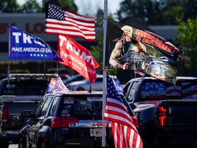 Vehicles fly pro-Trump flags prior to participating in a caravan convoy in Dunwoody, Georgia, U.S. September 5, 2020.
