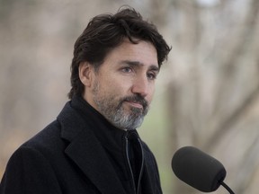 Prime Minister Justin Trudeau pauses after responding to a question about the holidays during a news conference outside Rideau Cottage in Ottawa, Friday, Nov. 20, 2020.