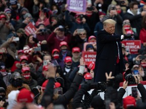 U.S. President Donald Trump gestures towards the audience while arriving to speak at a 'Make America Great Again' rally in Waterford, Michigan, U.S., on Friday, Oct. 30, 2020.