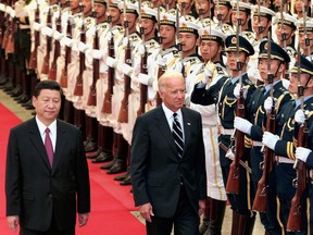 Chinese Vice-President Xi Jinping, left, accompanies U.S. Vice-President Joe Biden to view an honour guard during a welcoming ceremony inside the Great Hall of the People in Beijing, in 2011.