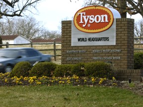 In this Jan. 29, 2006 file photo, a car passes in front of a Tyson Foods Inc., sign at Tyson headquarters in Springdale, Ark.
