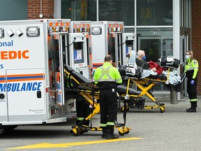 Paramedics transport an elderly man to a hospital in Mississauga, Ont., on Nov. 19.