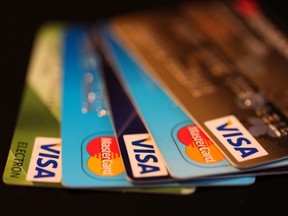 The logos of Mastercard Inc. and Visa Inc. sit on credit cards in this arranged photograph in Moscow, Russia, on Tuesday, April 1, 2014.