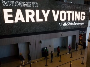 Early voters stand in line at the State Farm Arena on December 14, 2020 in Atlanta, Georgia.